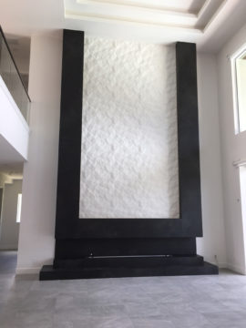 The fireplace features crush texture panels surrounded by sintered stone panels.