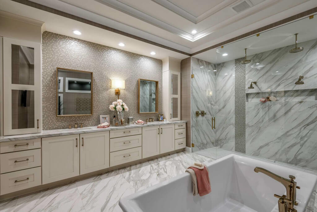 a large indoor luxury bathtub with two person shower from a home builder