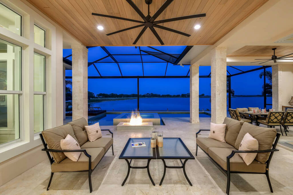 a custom home lanai with pool, seating area, fireplace and open floor plans