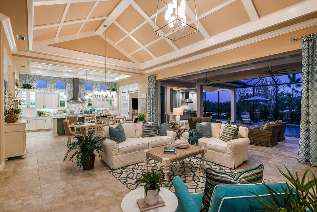 a home with a large Custom living room build and chandelier