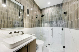 a Custom bathroom with a large tub and sinks with mirrors in a home with a modern build