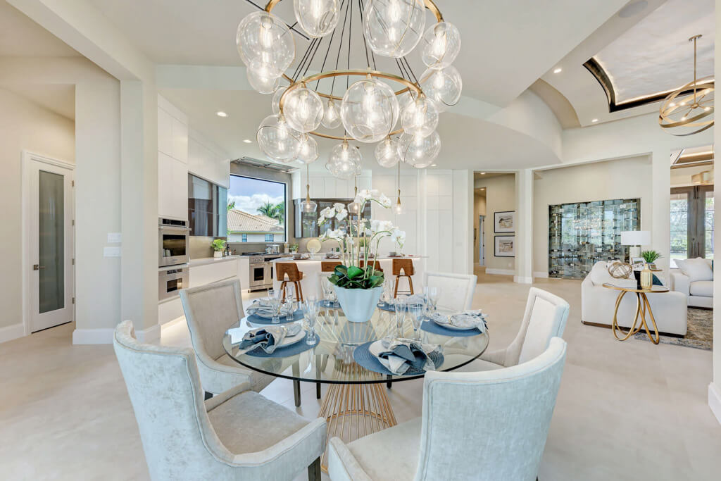 a home with a large Custom living room build and chandelier