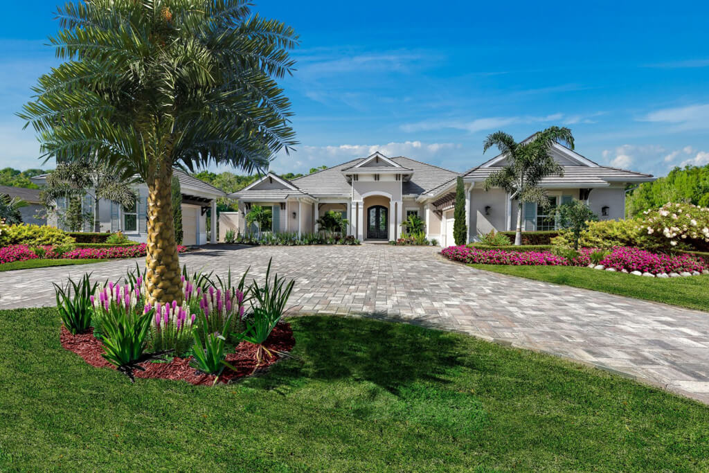 a custom home exterior with palm tree and brick driveway design