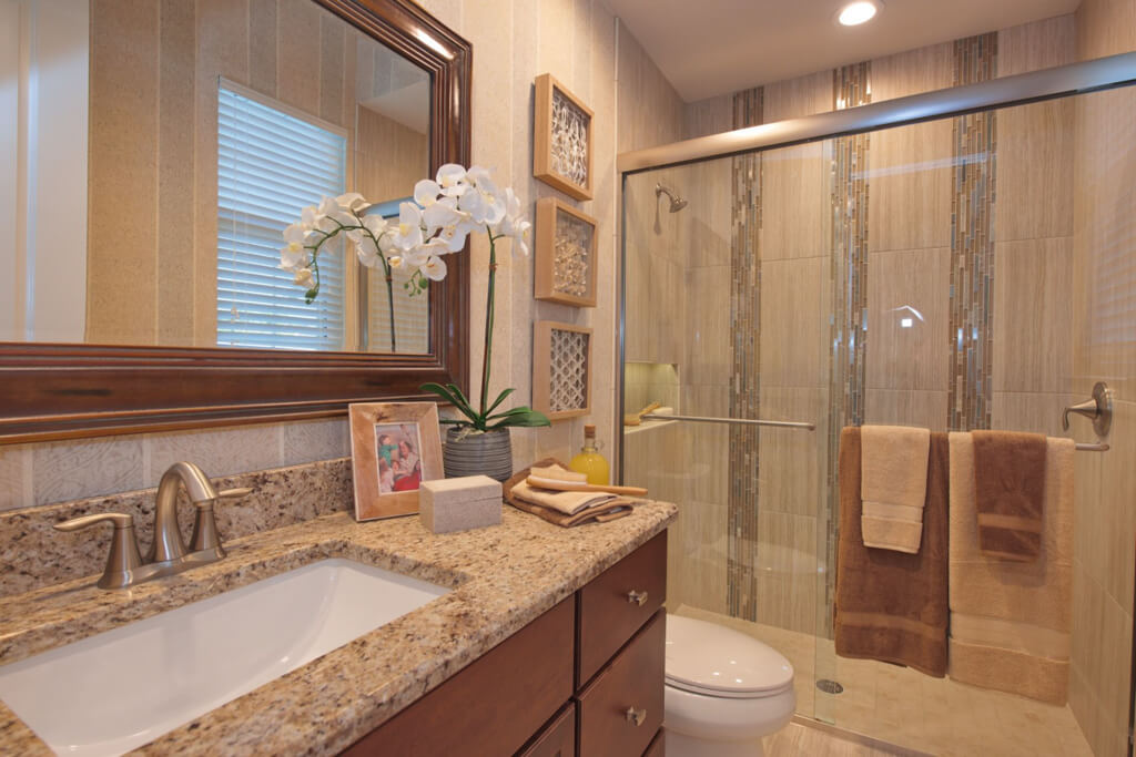 a Custom bathroom with a large shower and sink with mirrors in a home with a modern build