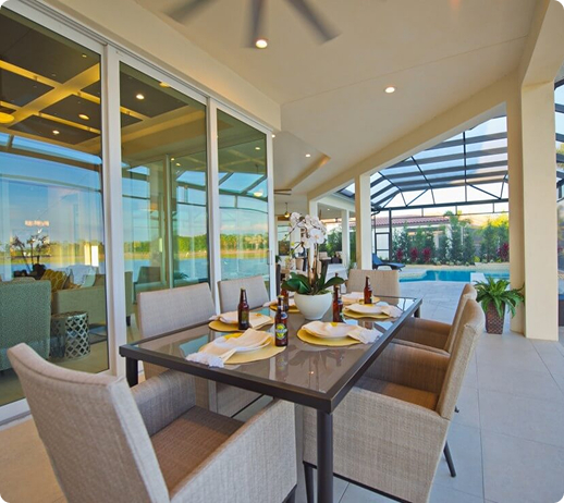 Covered outdoor seating area in a Florida luxury custom home designed by Lee Wetherington Homes, showcasing outdoor living and craftsmanship.