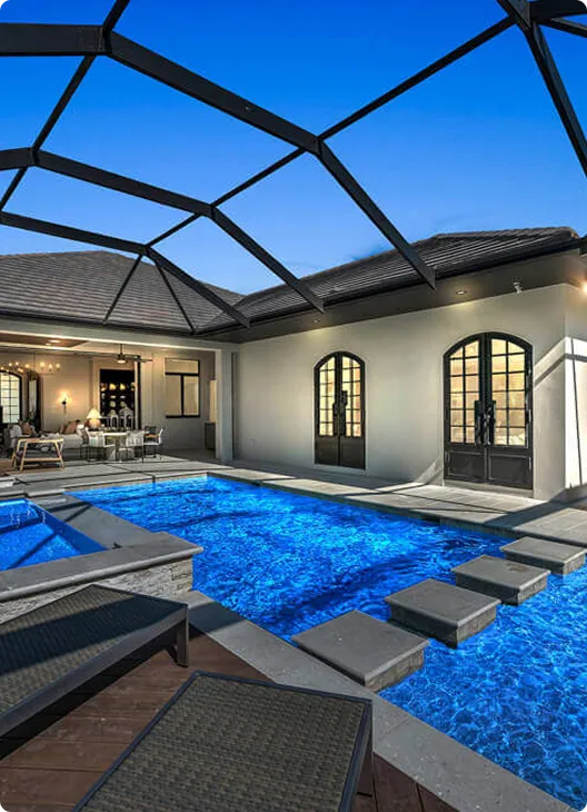Outdoor kitchen design by Lee Wetherington Homes featuring a luxury custom home with a resort-style pool and outdoor kitchen