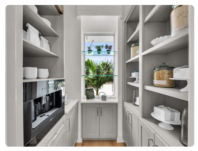 Luxury kitchen storage and cabinetry detail in a Florida custom home built by Lee Wetherington Homes showcasing craftsmanship and organization.
