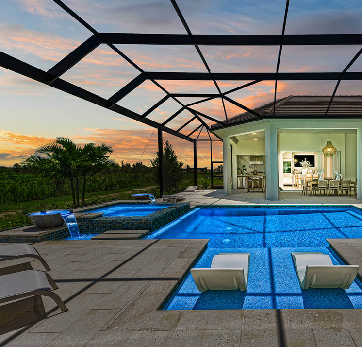 Screened lanai pool and outdoor living area of a luxury home in Florida at sunset.