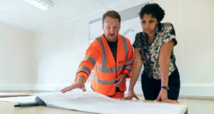 Custom home builder leading on-site plan review with subcontractor to ensure precise coordination and high standards throughout the custom home building process.