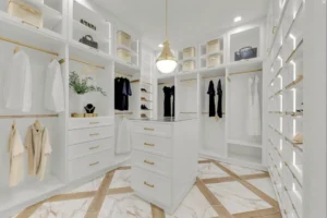 Warm minimalist luxury home interior designed by custom home builders featuring natural wood finishes, layered textures, soft lighting, and timeless coastal-inspired materials.