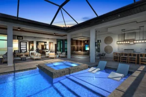Luxury new home construction featuring a custom Florida home with an indoor-outdoor living space, covered lanai, resort-style pool, spa, and outdoor kitchen designed by Lee Wetherington Homes.