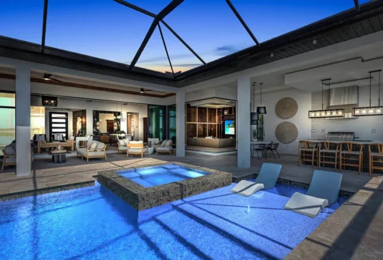 Luxury new home construction featuring a custom Florida home with an indoor-outdoor living space, covered lanai, resort-style pool, spa, and outdoor kitchen designed by Lee Wetherington Homes.