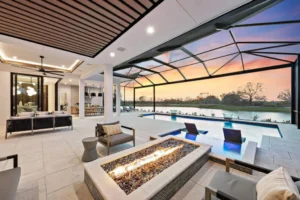 Indoor-outdoor living with an expansive covered lanai, pool, fire feature, and comfortable outdoor seating