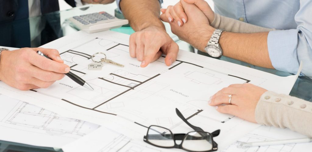 People at Lee Wetherington Homes Design Center looking at blueprints